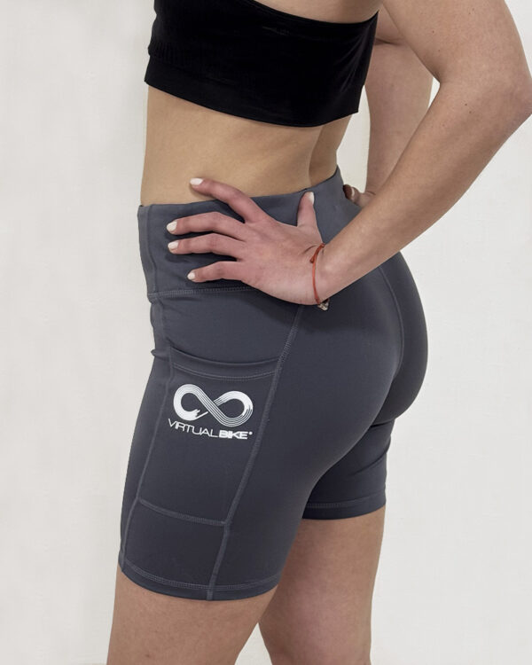 Mujer de perfil utilizando una calza con el logo de Virtual Bike